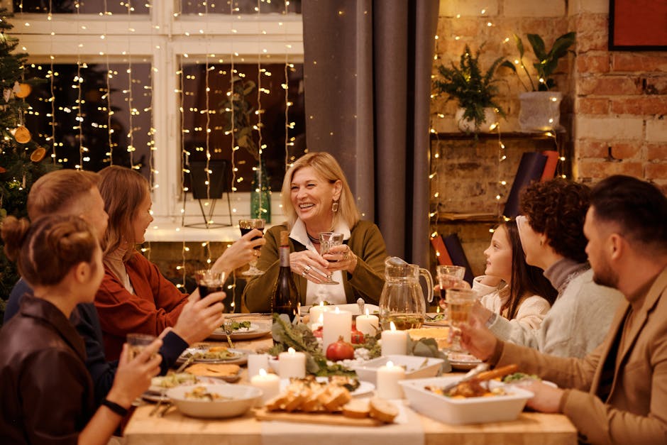 A joyful family gathering around a festive Christmas dinner table indoors, full of smiles and holiday cheer.