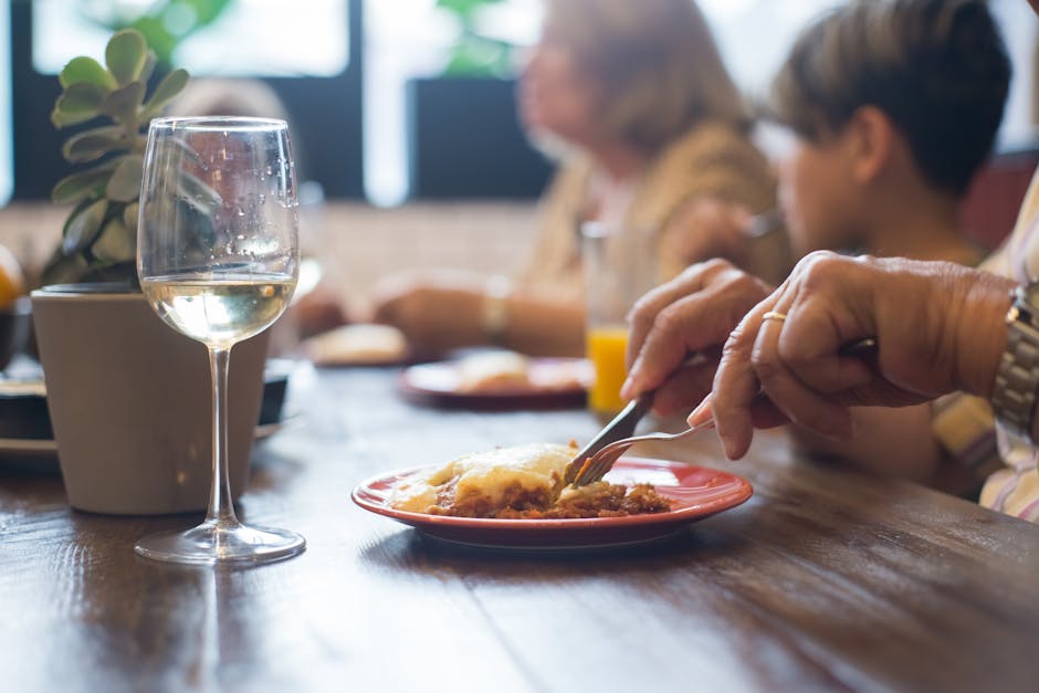 A close-up of a dining scene in Portugal with wine and a meal, highlighting a social atmosphere.